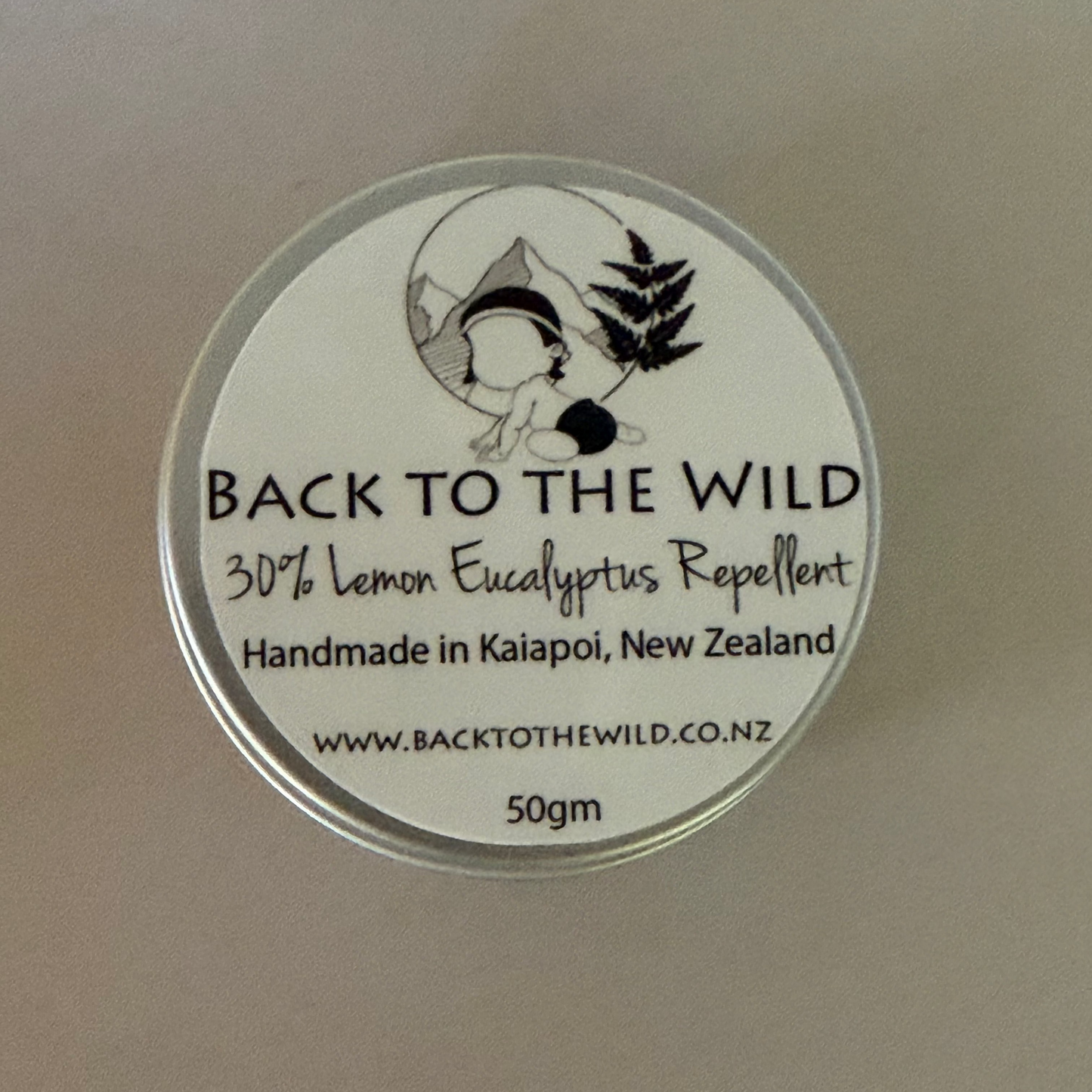 Round label with 'Back to the Wild' text and branding on a beige background
