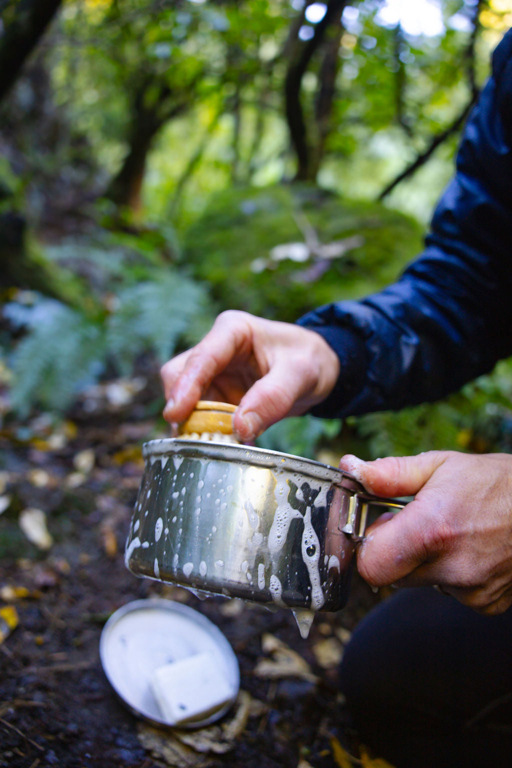 Cleaning soap Solid castile camping soap with pot in a forest setting